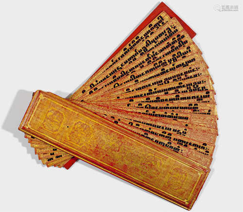 A PRAYER BOOK (KAMAVASA) OF LACQUERED WOOD AND TEXTILE. Burma, 19th c. L 6.5 cm. 12 double-sided folios in Pali, two with illuminations on one side, writing on the other. Minor chips.