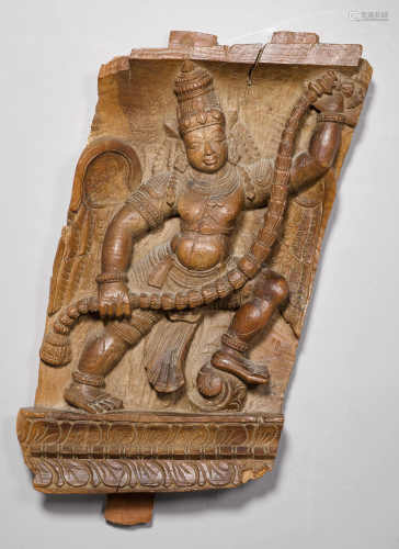 A WOODEN TEMPLE WAGON PANEL CARVED WITH GARUDA AMID LOTUSES AND GARLANDS. India, H ca. 56 cm.