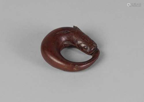 A Japanese carved wood ring toggle, 19th century, carved as a catfish, 6cm long