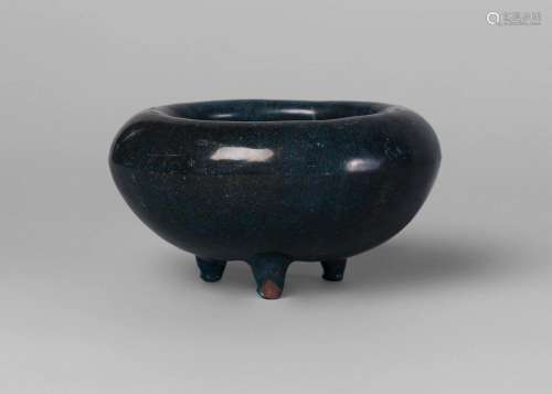 An unusual Chinese monochrome water coupe, 18th/19th century, with inverted rim and overall thick dark blue glaze, on three short feet, 11.5cm diameter, 6.5cm high