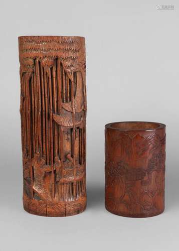 A Chinese bamboo brush pot, 19th century, carved in low relief with a moutainous landscape, 15cm high, and a 20th century bamboo brush pot carved with figures in a bamboo forest, 30.5cm high (2)