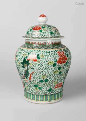 A Chinese export porcelain wucai jar and cover, late 19th century, painted in enamels with Buddhist lions on a foliate scroll ground, unmarked, 34cm high