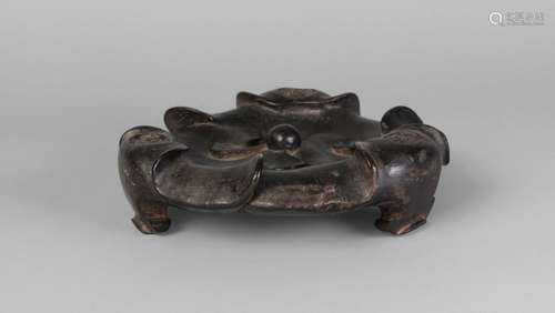 A Chinese hardwood tripod censer stand, 18th century, carved as lotus pads, with three ruyi-shaped feet, 20cmm diameter