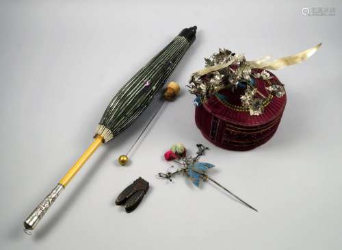 A Chinese woven opera hat, early 20th century, surmounted in silver foil with a bird and blossoming prunus, 24cm high, a kingfisher hair pin, a mid 20th century cicada box, a Chinese silk parasol, and a damascened hair pin decorated in gilt with a dragon (5)