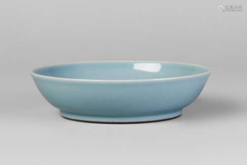 A Chinese porcelain claire de lune saucer dish, Qianlong mark, Republic period, with steep sides and cafe au lait foot rim, underglaze blue seal mark to base, 15cm diameter