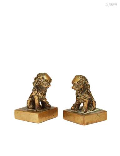 A pair of Chinese bronze seals, Qianlong period, modelled as a male and female Buddhist lion seated on a square base, inscribed Zhi Zhe Le and Ren Zhe Shou (wise man has happiness and benevolent man has long life), 5cm high