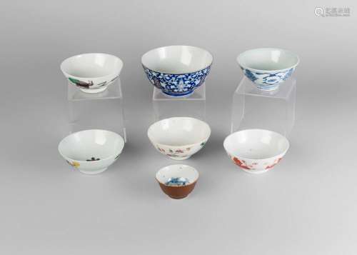 Seven various Chinese export porcelain bowls, late 19th century, comprising an enamel decorated blue ground bowl decorated with lotus blooms and meandering scrolls, Daoguang iron red seal mark and period, 13.5cm diameter, 6.5cm high, three famille rose decorated bowls depicting floral sprays and crabs, 12cm diameter, two bowls painted in underglaze blue, and a 19th century bowl painted in over glaze iron red with floral sprays (7)