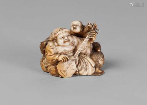 A Japanese ivory small okimono, late 19th/early 20th century, carved as Daikoku playing an instrument seated by a bale of rice, with a boy and two rats, signed, 5cm wide