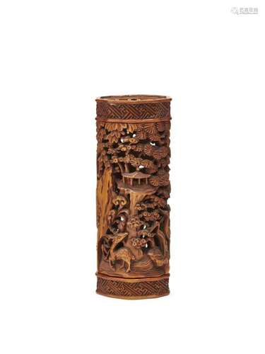 A Chinese boxwood cricket cage, 18th/19th century, finely carved with a scholar in a hut, beneath a crane in flight amidst pine trees, and with a deer to the reverse, 9cm long