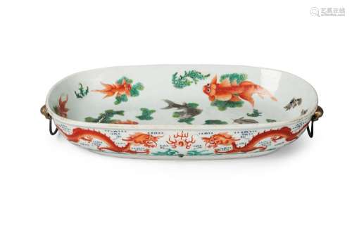 A Chinese porcelain oval serving platter, Jiaqing mark and period, painted to the interior with carp swimming amongst pond weeds, and to the exterior with two pairs of confronting dragons amidst cloud wisps above crashing waves, with Buddhist lion mask handles, iron red seal mark, 33cm x 19cm