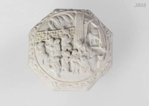 A Chinese biscuit porcelain octagonal seal paste box and cover, impressed Qianlong seal mark but 19th century, the cover finely carved with a group of boys playing, inside a border decorated with the Eight Buddhist Emblems, the base carved with five bats (wufu) and peaches on a ground of clouds, the bats and parts of the raised decoration to the cover with pale glaze, the rest unglazed, 8cm diameter Provenance: Private UK Collection
