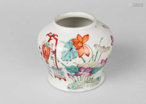 A Chinese porcelain jar, Qianlong mark but mid 19th century, painted in famille rose enamels with lotus issuing from a pond, iron red seal mark to base, 12cm high