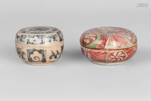 A Chinese porcelain circular seal paste box and cover, Ming dynasty, 16th century, painted in underglaze blue with peoonies and panels of floral scrolls, 8cm diameter, 5cm high, and a circular red-ware circular seal paste box and cover, Ming dynasty, painted to the cover with a hare, 9.5cm diameter (2)