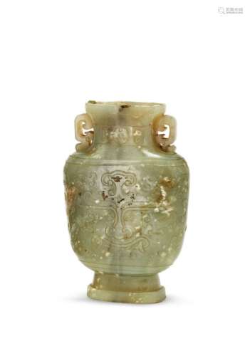 A Chinese green jade archaistic vase, 18th century, of flattened form, carved in low relief with tao-tieh to both sides, with archaic pierced handles, the stone of dark green tone with calcite inclusions and dark vertical streak running through stone, 13cm high (lacking cover) Provenance: Private UK collection