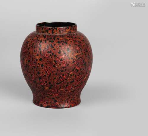 A rare Chinese marbled xipi lacquer vase, 17th century, decorated with abstract design in shades of red, ochre, and black lacquers, of ovoid form with wide mouth, flat, black lacquered base, 9.5cm high Notes: Xipi translates literally as 'rhinoceros hide'. The technique involved applying layers of different coloured lacquers over an uneven surface. It is then polished so that the layers appear as different colours, in an abstract pattern. Cf. For a similarly decorated 16th century box, see S