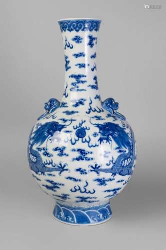 A large Chinese porcelain bottle vase, Qianlong mark, 20th century, painted in underglaze blue with two confronting dragons amidst flames and cloud wisps, moulded to the shoulders with lion mask and ring handles, underglaze blue seal mark, 49cm high