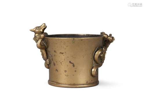A Chinese polished bronze censer, Zhengde mark, 19th century, of flared cylindrical form, the sides surmounted with two chi-long dragons, 8.5cm high, 12cm wide