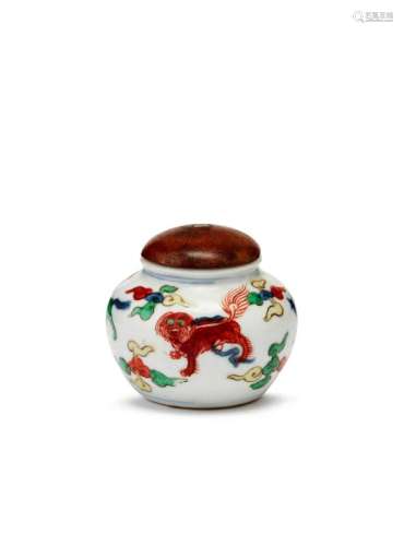 A Chinese porcelain doucai miniature jar, Kangxi, painted with four beasts amidst cloud wisps, unglazed flat base, 4cm high, 5cm diameter, later wooden cover