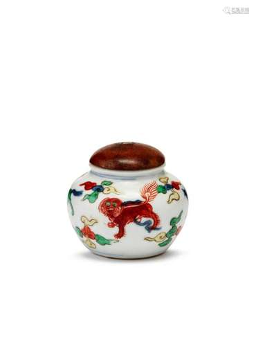 A Chinese porcelain doucai miniature jar, Kangxi, painted with four beasts amidst cloud wisps, unglazed flat base, 4cm high, 5cm diameter, later wooden cover