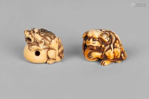 Two Japanese ivory netsuke, 19th century, carved as Buddhist lions crouched on a ball, one signed, 3cm high (2)