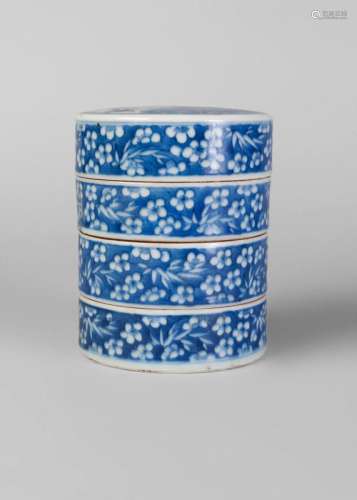 A Chinese porcelain four section cylindrical box, late Qing dynasty, painted in underglaze blue to the cover with a dragon above a carp in crashing waves, and with prunus and bamboo to the body, unmarked, 13cm high