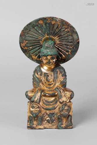 A Chinese gilt bronze Western Sui style figure of Sakyamuni, seated in meditation on a throne flanked by two crouching lions, with circular mandala cast as 'the wheel of the law', 20cm high