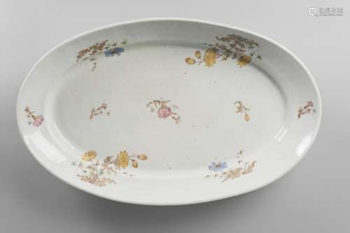 A huge Chinese porcelain oval charger, Jiaqing period, painted in famille rose enamels with chrysanthemum, peony and bamboo sprays, Yi Xiu Tang hallmark to base, 63cm long, 39cm wide, 9.5cm deep