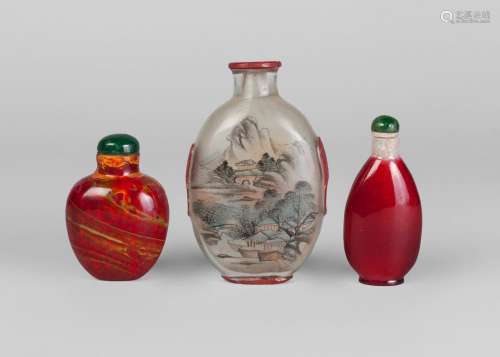 A Chinese inside painted glass snuff bottle, early 20th century, decorated with a cock to one side and a landscape scene to the other, 9cm high, and two glass snuff bottles (3)