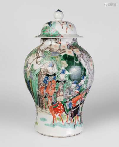 A Chinese porcelain famille verte jar and cover, late Qing dynasty, painted in enamels with a procession, figures seated in a howdah on an elephant, and figures on horseback, unmarked, 34cm high
