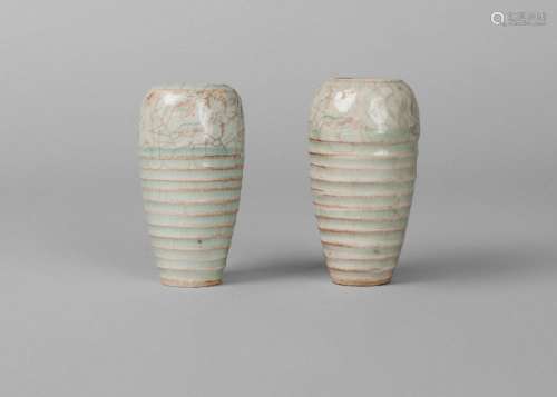 A pair of Chinese miniature qingbai vases, Song dynasty, of ribbed ovoid form, incised with band of floral motifs beneath the rim, unglazed, recessed base, 7.5cm high