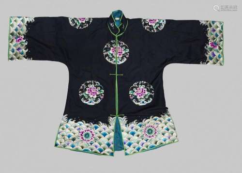 A Chinese silk embroidered jacket, 20th century, decorated with floral medallions on a dark blue ground