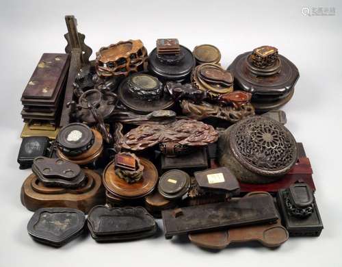 A large collection of predominantly Chinese wood stands, 18th-20th century