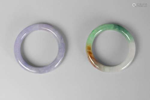 Two Chinese hardstone bangles, 20th century, one grey, the other apple-green, 8cm diameter