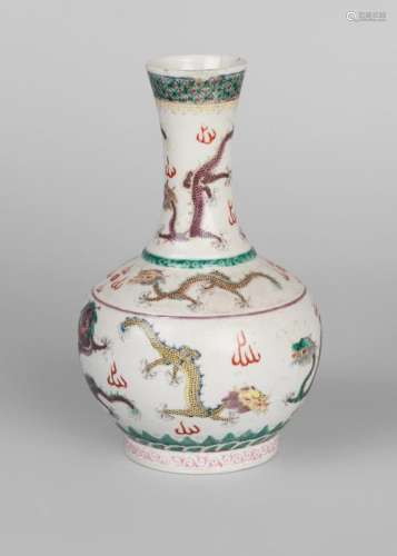 A Chinese porcelain 'nine dragons' bottle vase, Qianlong mark, mid 19th century, painted in famille rose enamels with nine dragons to the neck, shoulder, and body on an incised ground, seal mark to base, 22cm high