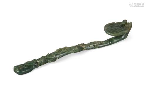 A Chinese spinach jade ruyi sceptre, late Qing dynasty, the head carved with peaches, the shaft carved with prunus blossom, 38cm long