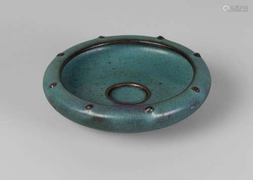 A Chinese Junyao style circular brushwasher, with studded, inverted rim and central recess, with single purple splash, 14cm diameter