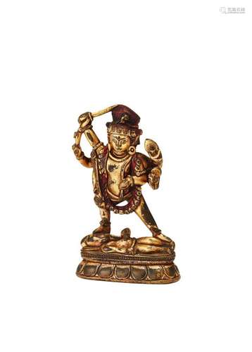 A Western Tibet gilt bronze figure of Achala, 12th/13th century, modelled standing on Ganesh, 9cm high