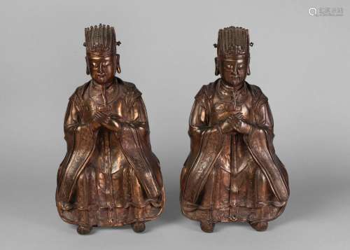 A pair of large Chinese gilt bronze figures of Daoist officials, 16th/17th century, each figure with long flowing beard, their hands clasped in front of their chests, wearing court robes with engraved borders, and with ruyi-toed feet, 37cm high Notes: These figures likely represent the Heavenly Official Tianguan, one of the Three Star Gods, who bestows happiness. Cf. For similar examples, see:- Christie's New York, Fine Chinese Ceramics & Works of Art, 15th -16th March 2015, Lot 3194 Sotheb