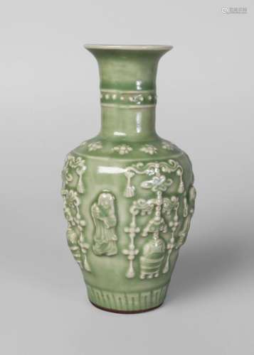A Chinese Yuan style celadon glazed 'celebration' vase, Qing Dynasty, 18th/19th century, of baluster form, moulded with four figures in celebration, 18cm high