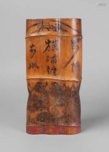 An unusual Japanese bamboo brush pot, late 19th/early 20th century, carved in low relief with a poem above a landscape scene, 31cm high