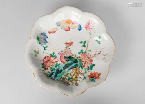 A Chinese porcelain leaf-shaped footed dish, mid 19th century, painted in famille rose enamels with an exotic bird amongst chrysanthemum sprays and with lotus blooms to underside, iron red seal mark, 22cm wide