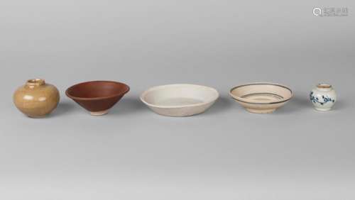 A Chinese Qingbai glazed shallow dish, Song dynasty, 12th/13th century, unglazed base and rim, 13.5cm diameter, a Song dynasty brown glazed conical bowl, 10.5cm diameter, a Ming shallow bowl, 10.5cm diameter, a Ming porcelain blue and white jarlet, 4cm high, and a Song dynasty celadon glazed jarlet, 6cm high, with label to base 'Ex Collectis Erik Hancock' (4)