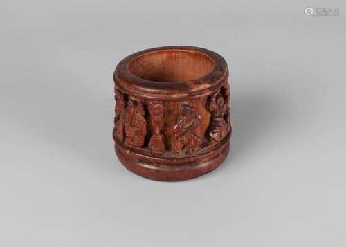 A Chinese bamboo 'Eight Immortals' small brush pot, late Qing dynasty, carved in deep relief to the sides with the Eight Immortals, 8cm high