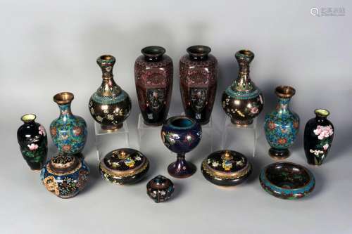 Fourteen pieces of Chinese and Japanese cloisonne, 19th-20th century, to include a pair of hexagonal baluster vases finely decorated with panels of phoenixes and dragons, a pair of garlic-head vases, and two circular boxes and covers, 8cm-25.5cm high