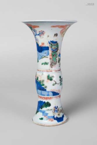 A Chinese porcelain wucai gu vase, Wanli mark, Qing dynasty, late 17th century, the top section painted with a boy presenting a gift in a garden landscape, the lower section painted with two figures playing wei qi in a garden landscape, underglaze blue six-character mark within a double ring to base, 24cm high