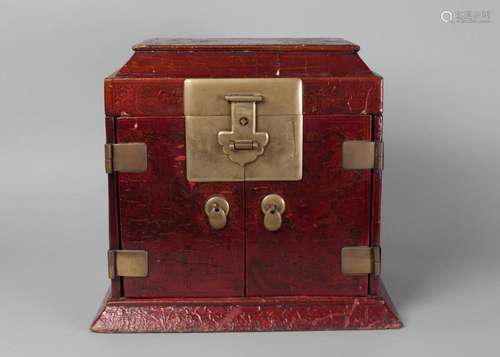 A Chinese red-lacquer table top cabinet, 19th century, painted throughout with various figures and landscapes, painted to underisde of hinged lid and inscribed within an Artemisia leaf, with two doors enclosing arrangement of three drawers, 38cm high, 40cm wide