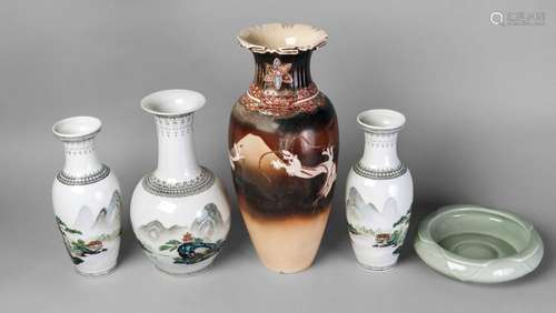 Three Chinese porcelain famille rose vases, 20th century, painted with landscapes, 29cm and 25cm high, a Chinese celadon lotus moulded bowl, 20th century, 21cm diameter, and an early 20th century Japanese Satsuma vase (5)