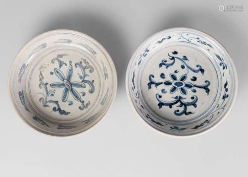 Two similar Annamese porcelain bowls, 16th century, painted in underglaze blue with chrysanthemum, and with lappets to the underside, 23cm diameter