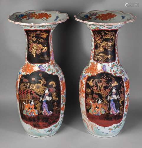 A pair of large Japanese Arita porcelain vases, Meiji period, set with lacquer panels painted with birds amidst chrysanthemum blooms, on a ground enamelled with birds amidst peony and chrysanthemum, 76cm high