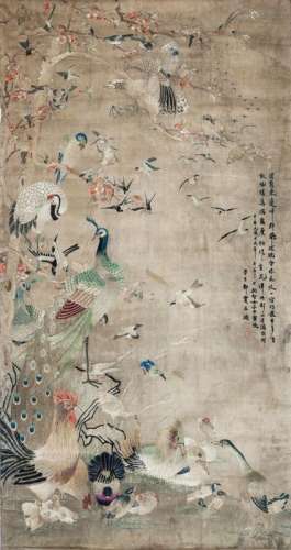 A large Chinese silk embroidered 'Thousand Birds' picture, Qianlong period, finely decorated with various birds including swallows, peacocks, chickens, and kingfishers, embroidered with four rows of calligraphy and two seal marks, 125cm x 71cm